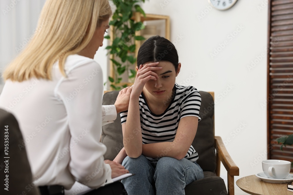 Psychologist working with teenage girl in office Psychologist working with teenage girl in office