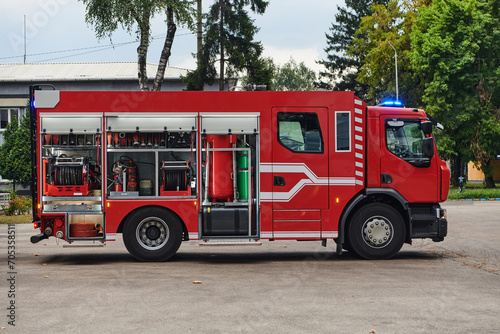 A state-of-the-art firetruck, equipped with advanced rescue technology, stands ready with its skilled firefighting team, prepared to intervene and respond rapidly to emergencies, ensuring the safety