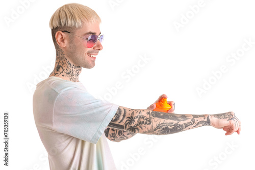 Tattooed man applying sunsc...