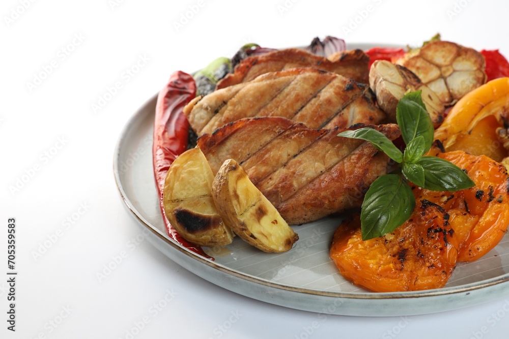 Plate with tasty grilled vegetables, meat and basil isolated on white Plate with tasty grilled vegetables, meat and basil isolated on white