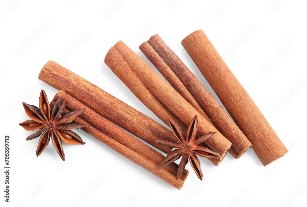 Aromatic cinnamon sticks and anise stars isolated on white, top view