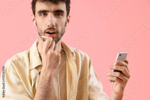Young man with mobile phone...