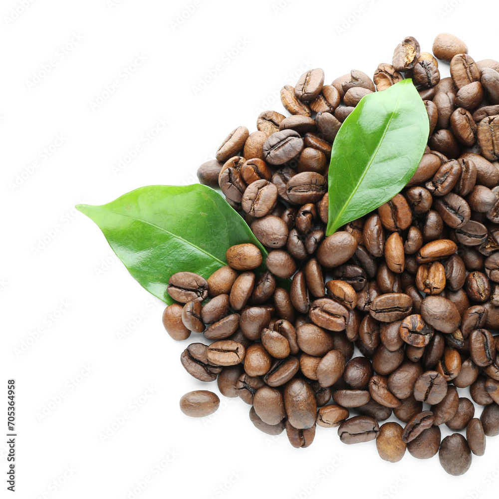 Obraz premium Freshly roasted coffee beans with green leaves, aromatic beverage ingredient for morning drink and cafe culture, this combination represents the natural origin and aromatic quality of coffee