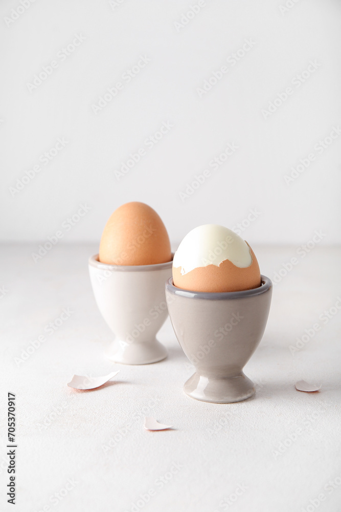 Holders with boiled chicken eggs on white background Holders with boiled chicken eggs on white background