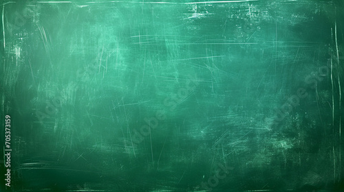 A texture of chalk rubbed out on green blackboard or chalkboard background. School education, backdrop for learning concept. photo