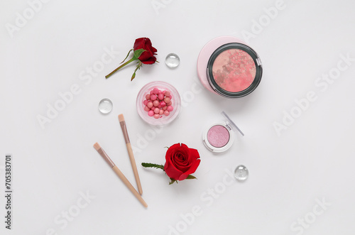 Composition with makeup products and beautiful red rose flowers on white background