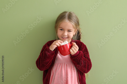 Happy little girl holding c...