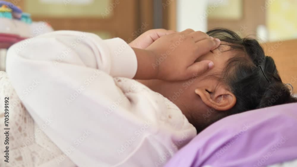 a upset child girl cover her face with hand 