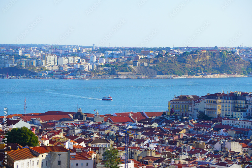 View of Lisbon, Capital city of Portugal with a boat crossing the river