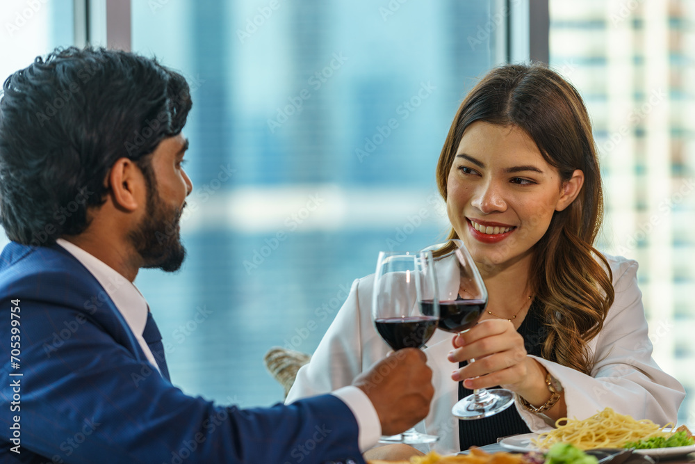 Caucasian woman having dinner with Indian man Inside the restaurant happily Caucasian woman having dinner with Indian man Inside the restaurant happily
