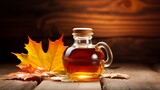 Indulge in the allure of maple syrup, encased in a stunning glass bottle, perched on a table beside a golden maple leaf, awaiting delightful consumption.