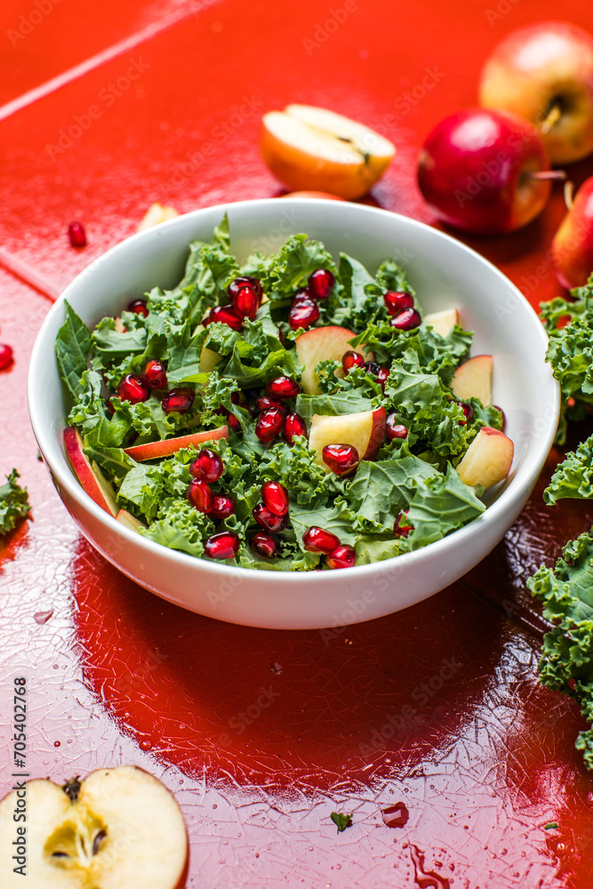 Hokkaido apple and quinoa salad with kale, pomegranate, spring onion and toasted sunflower seeds. Healthy homemade food. Vegan food
