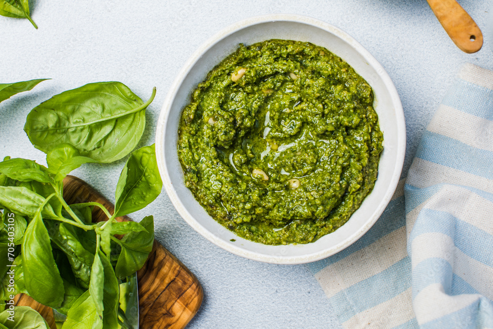 Pesto sauce and ingredients on white background, copy space.Food frame italian food background healthy food concept or ingredients for cooking pesto sauce on a vintage background top view with copy sp Pesto sauce and ingredients on white background, copy space.Food frame italian food background healthy food concept or ingredients for cooking pesto sauce on a vintage background top view with copy sp