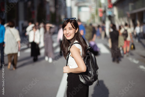 Urban chic, Trendy young lady in Tokyo, radiating positivity and success, showcasing the dynamic lifestyle of modern Japanese women. © Jirawatfoto