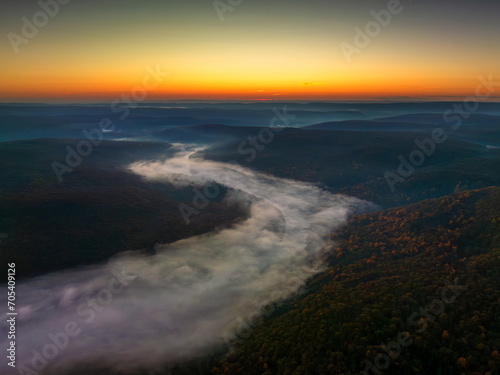 Aerial view of river in the forest at sunrise