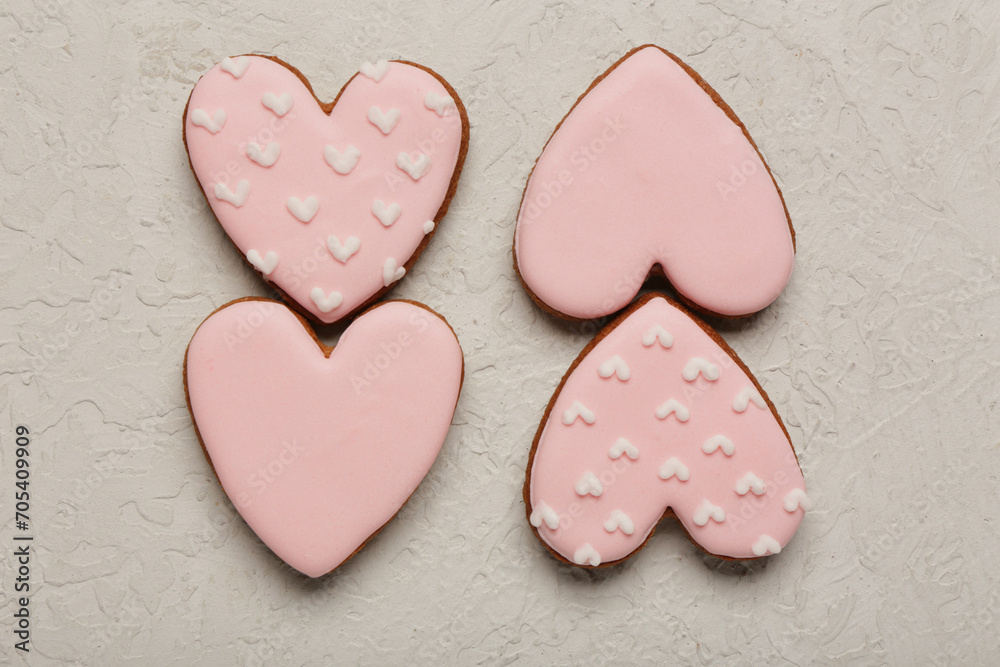 Obraz premium Tasty heart shaped pink cookies on white grunge background. Valentine's Day celebration