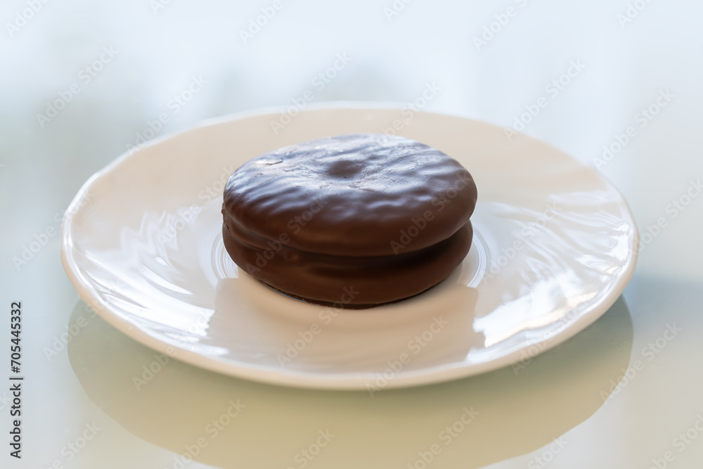 Tasty choco pie on white tiled table, close up. Tasty choco pie on white tiled table, close up.