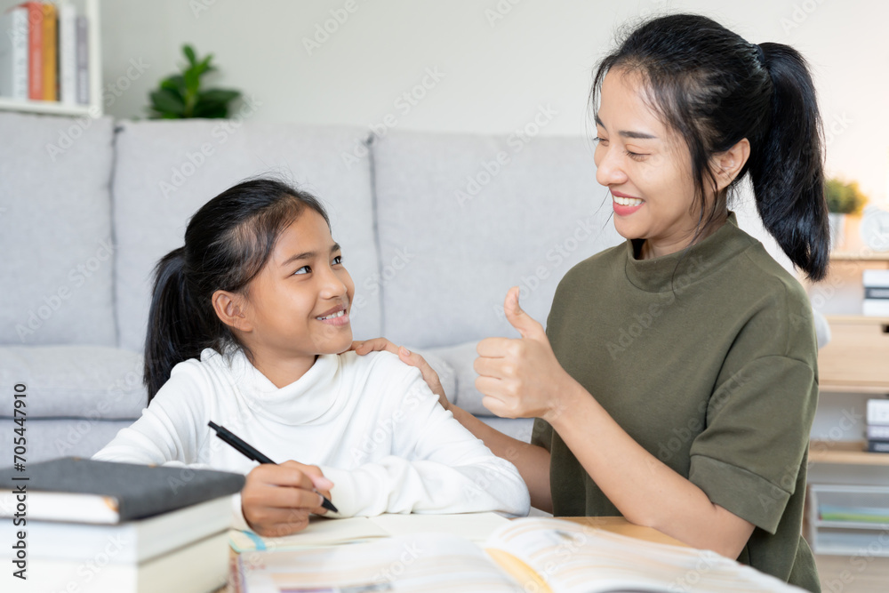 Mother teaching lesson for daughter. Asian young little girl learn at home. Do homework with kind mother help, encourage for exam.. Girl happy Homeschool. Mom advice education together. Mother teaching lesson for daughter. Asian young little girl learn at home. Do homework with kind mother help, encourage for exam.. Girl happy Homeschool. Mom advice education together.