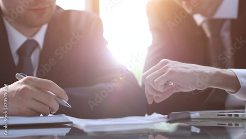 Closeup businessman sign contract or legal document with pen in his hand during corporate meeting for business deal photo