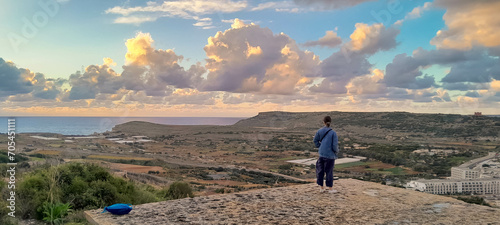 Tourist enjoying view of coast in Mafa Peninsula Malta. photo