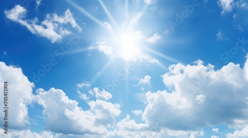 Sun with rays and glare clear blue sky and clouds Sunshine in a blue sky with white cumulus clouds in bright weather