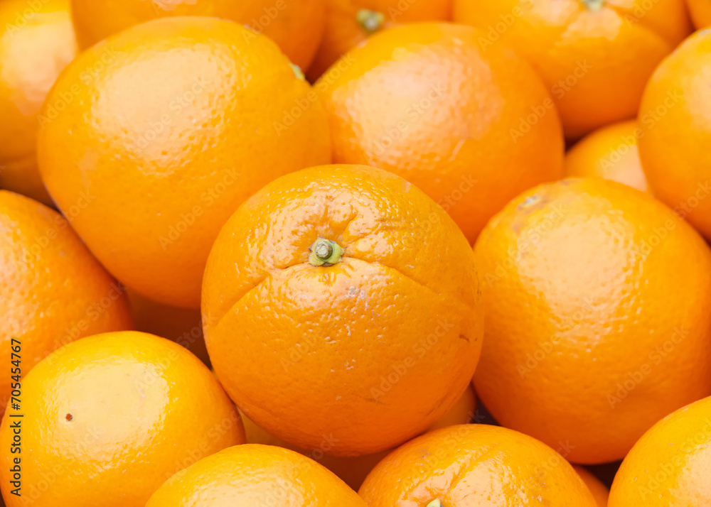Close up of fresh organic whole navel oranges in a display crate for sale at market. Close up of fresh organic whole navel oranges in a display crate for sale at market.