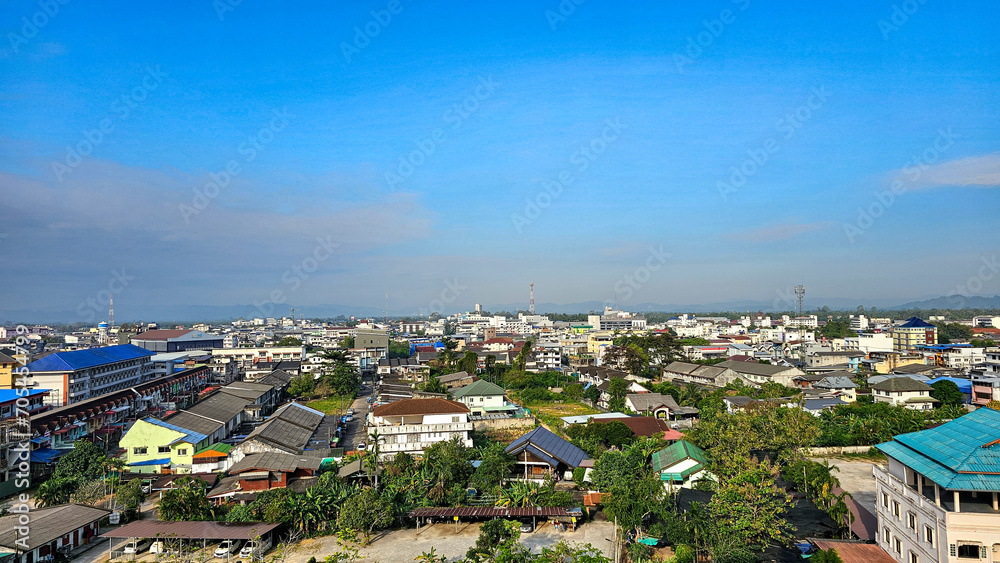 High angle shot view to the house-tops in Chumphon city is a southern of Thailand province city. Aerial view, Clear and bright day. city, landscape, village,building, school, sky, nature, clouds