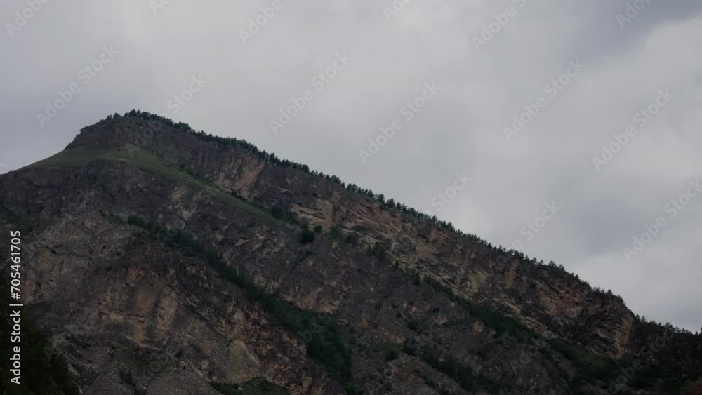 A mountain range against the background of a cloudy and gray sky. Shooting of mountainous terrain. A mountain range against the background of a cloudy and gray sky. Shooting of mountainous terrain.