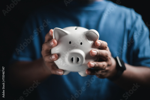 Happy businessman saving money on a piggy bank Saving ideas and money 