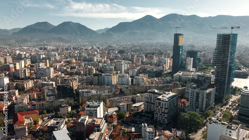 Aerial view of downtown Tirana Albania, rooftop view with mountains and scenic clouds in the background photo
