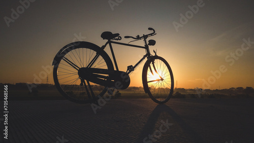 An old bicycle photographed at sunrise.