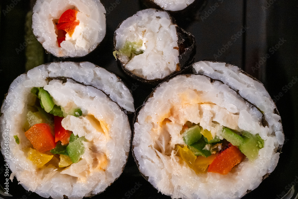 Chop sticks, mushrooms, noodle ramen, California rolls and Philadelphia rolls on a small plate on a pink background
Chop sticks, mushrooms, noodle ramen, California rolls and Philadelphia rolls on a small plate on a pink background