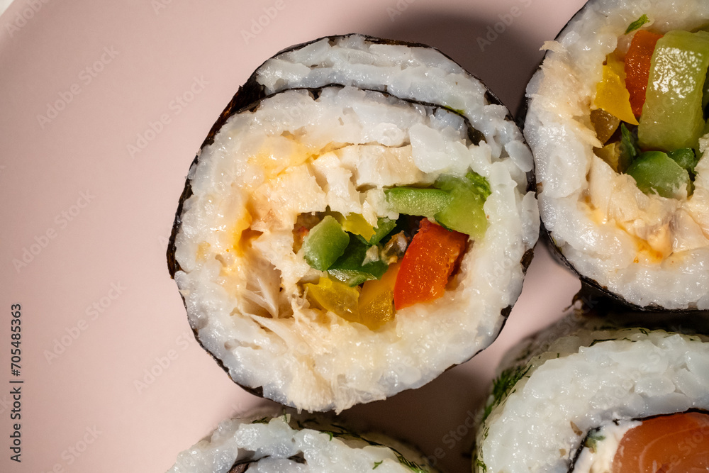 Chop sticks, mushrooms, noodle ramen, California rolls and Philadelphia rolls on a small plate on a pink background
Chop sticks, mushrooms, noodle ramen, California rolls and Philadelphia rolls on a small plate on a pink background