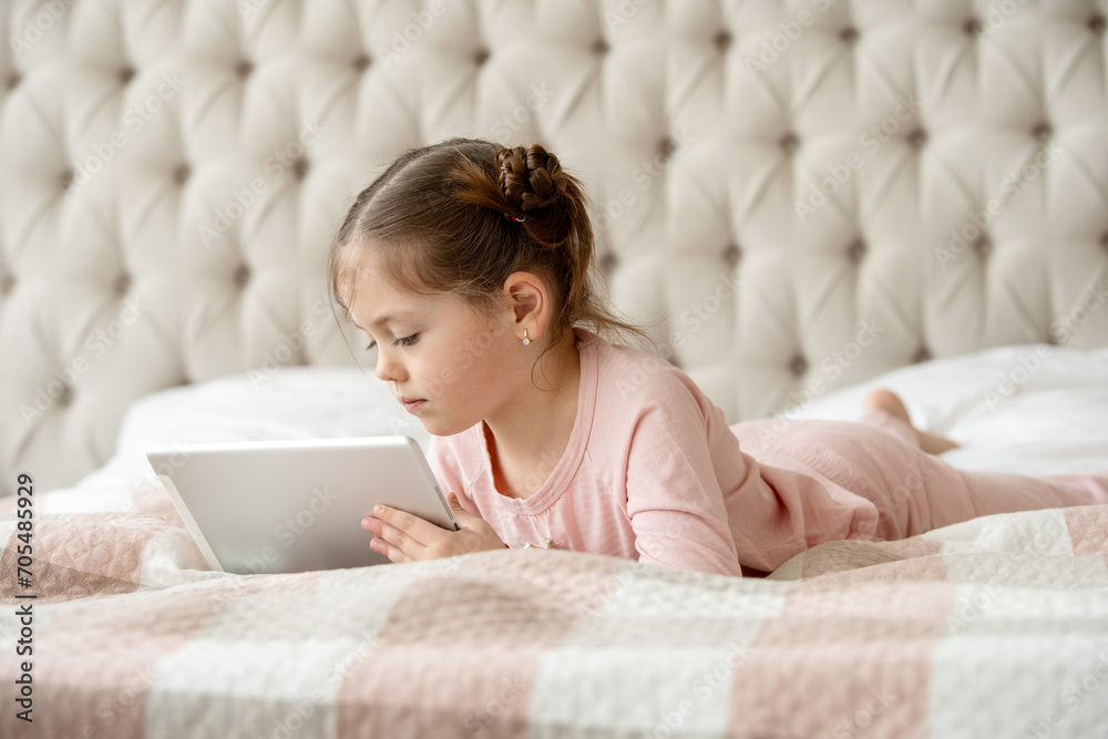 Technology, rest and young girl kid networking on social media or mobile app in bedroom at home Technology, rest and young girl kid networking on social media or mobile app in bedroom at home