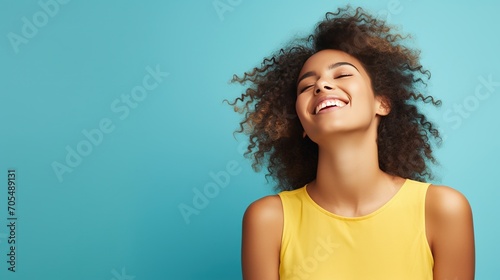 Portrayal of a joyous young woman against a solid color background photo