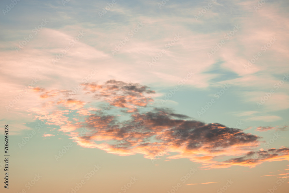 Fototapeta premium A beautiful sky tinted by the sun leaving vibrant shades of gold, pink, blue and multicolored. Clouds in the twilight evening and morning sky. Cloudy sky background in the evening and during the day.