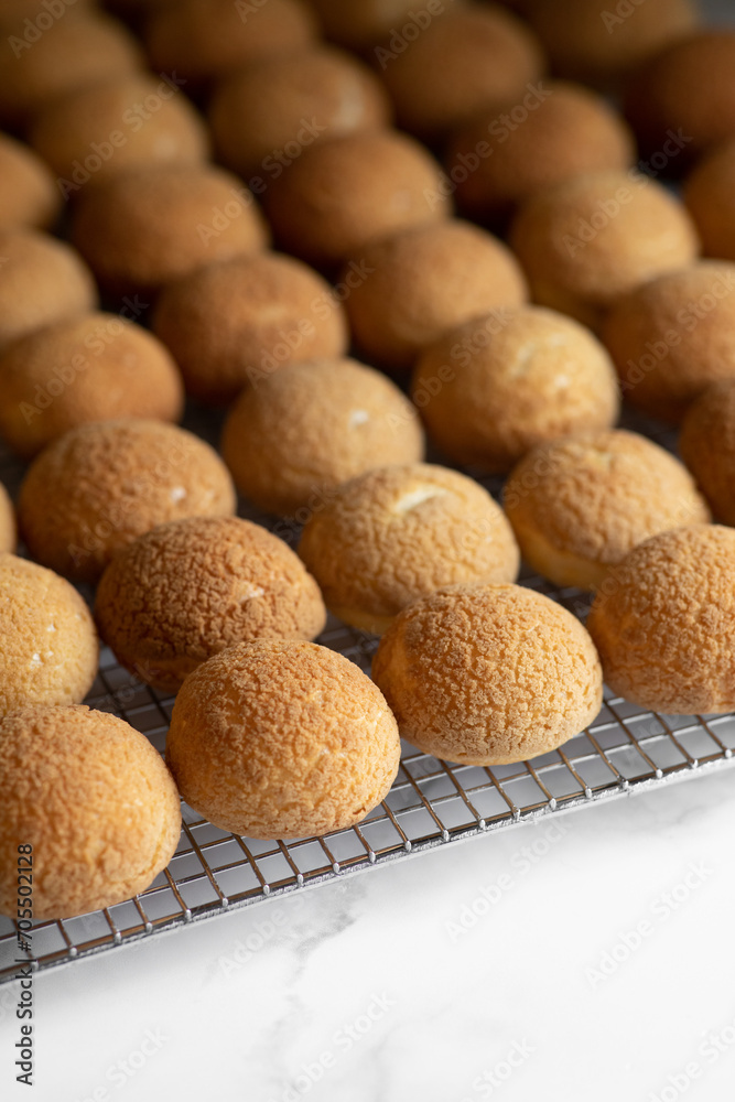 Freshly Baked eclair choux on a wire rack Freshly Baked eclair choux on a wire rack