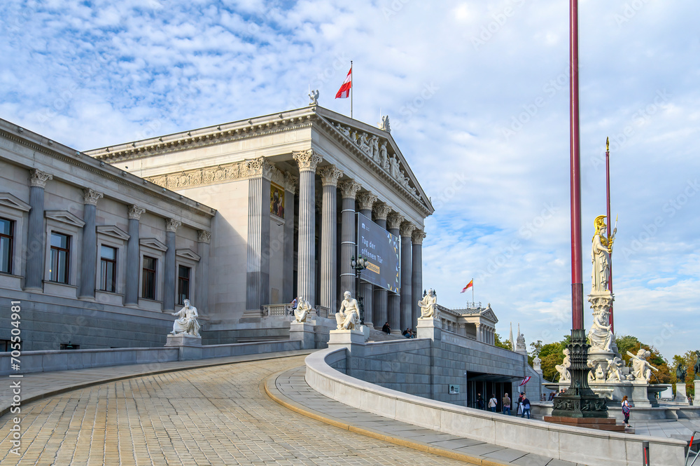 Naklejka premium The Austrian Parliament Building and the Pallas Athena Fountain in Vienna, Austria 