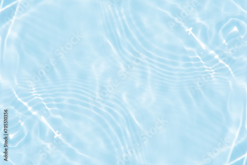 Fototapeta Naklejka Na Ścianę i Meble -  Bluewater waves on the surface ripples blurred. Defocus blurred transparent blue colored clear calm water surface texture with splash and bubbles. Water waves with shining pattern texture background.