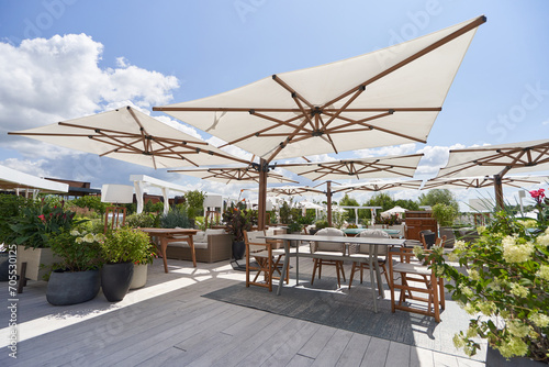 Large sun umbrellas in a street restaurant on a sunny day