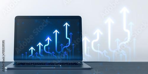 Close up of laptop computer at workplace with growing blue business chart arrows on blurry background. Success, trend and financial growth concept. 3D Rendering.