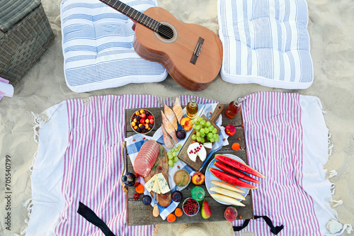Picnic on the beach at sunset in the style of boho