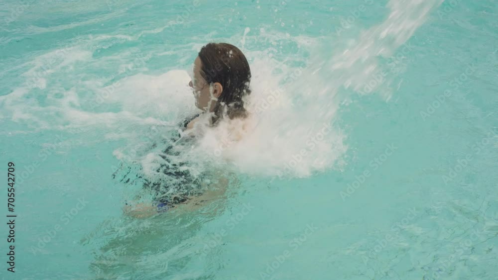 Woman relaxing with hydromassage in the swimming pool. Woman relaxing with hydromassage in the swimming pool.
