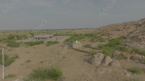 Aerial shot of ruins of Hindu temple in Nagarparkar surrounded by stones in Pakistan. photo