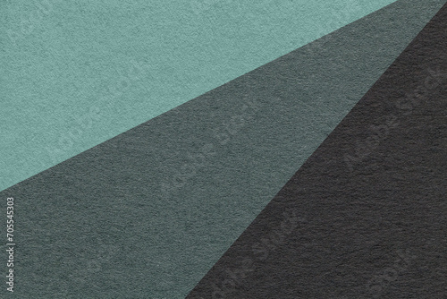 Texture of old craft cyan, teal and black color paper background, macro. Vintage abstract cardboard