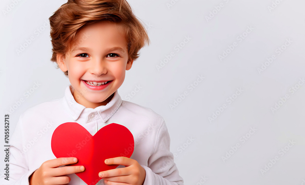 Holiday banner for Valentine's Day - boy holding a red heart on white background - copy space for text Holiday banner for Valentine's Day - boy holding a red heart on white background - copy space for text