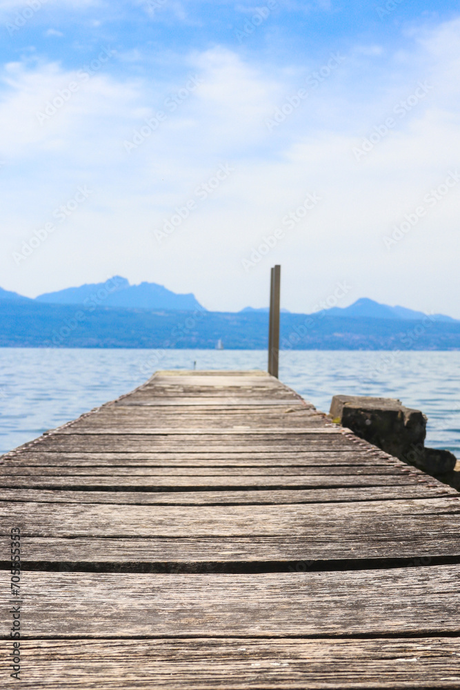 Wooden pier overlooking the Alps and Lake Geneva in Switzerland Wooden pier overlooking the Alps and Lake Geneva in Switzerland