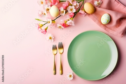  Table setting for celebrating easter. Plate, cutlery, eggs and spring flowers on the pink table top view, copy space for text