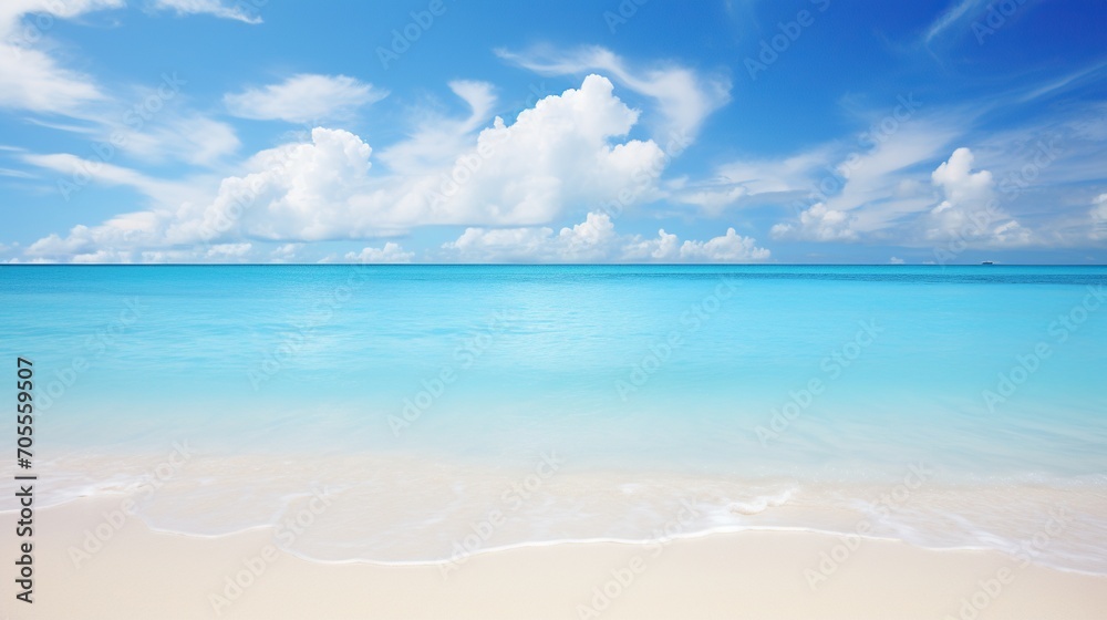 Serene beach landscape with vivid blue ocean under a clear sky, ideal for peaceful background.
