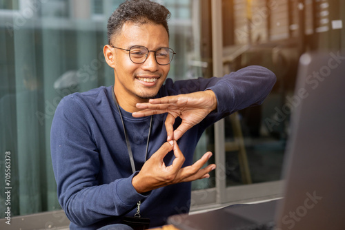 close up asian indian man make gesture hand about sign language to teaching or talking to colleague in office meeting room for business lifestyle concept photo